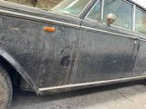 an old car that is parked on the side of the road
