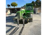 a picture of a green tractor parked in a parking lot