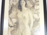 tableau représentant une femme nue, dans un cadre noir, accroché à un mur blanc