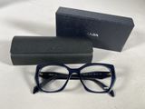 a pair of glasses sitting on top of a table next to a box