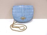 a small blue purse with a gold bee on it