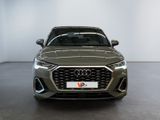 the front view of a grey audi vehicle parked in a showroom