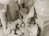 two figurines that are sitting on top of a table