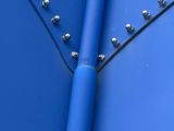 a blue umbrella with rivets on the top of it