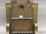 an image of a brass plate with a clock on top of it