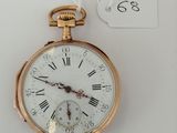 a gold pocket watch with roman numerals on it