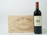 a bottle of wine sitting next to a wooden box