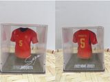 two pictures of a soccer jersey in a display case