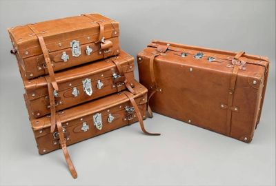 several pieces of luggage sitting on top of each other on a table