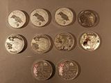 several different coins are arranged in a row on a table