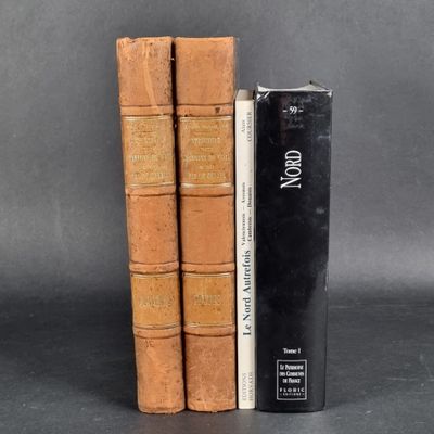 three books are stacked on top of each other on a table