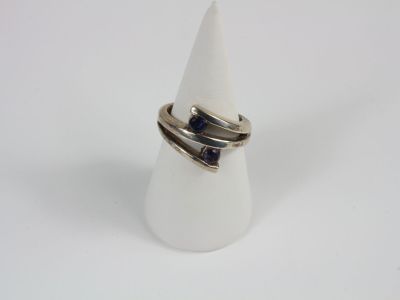 a close up of a ring on a white cone on a white surface