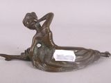 bronze statue of a woman sitting on her stomach with a note in her hand