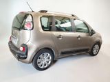 a small silver car that is parked in a room