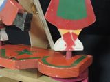 brightly colored wooden toys sit on top of a wooden table