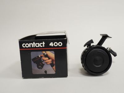 an image of a small camera sitting next to a box of contact 400