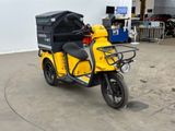 a small yellow motorcycle with a black box on the back