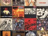 various album covers on a wall in a room