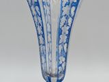 a blue and white vase sitting on a white surface