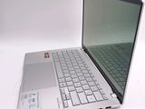 a laptop computer that is sitting on a white surface