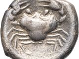 a close up of a silver coin with a crab on it