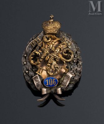 an image of a gold and silver broochle with a crown on it