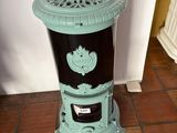 a blue and black stove sitting on a tiled floor