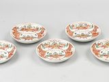four small plates with different designs on them on a table
