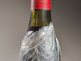 a bottle of wine that has been wrapped in plastic