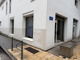 a white building with a blue sign on the side of it