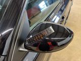 a close up of a car ' s side mirror with a sticker on it