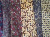 many different colored ties laid out on a table