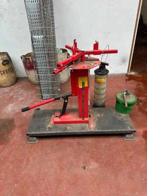 a red machine that is sitting on the ground