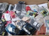 a cardboard box filled with assorted clothing and other items