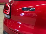 a close up of a red car with a sticker on it