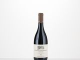 a bottle of red wine sitting on top of a table