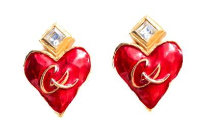 pair of red heart shaped earrings with gold accents on white background
