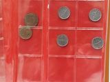 a lot of coins in a red box on a table
