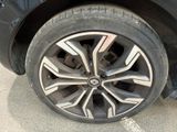 a close up of a car ' s tire on the street