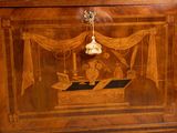 a wooden cabinet with a painting on it