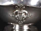 a silver bowl with a decorative design on it
