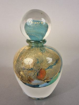 a small glass vase with a sand inside of it