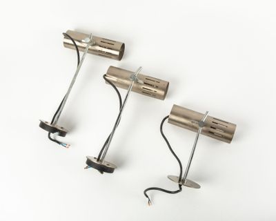 two lights that are attached to a metal pole