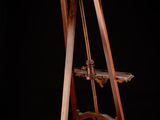an old wooden easer with a bird on it against a black background