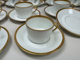 many cups and saucers on the table ready to be served