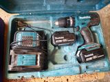 two power tools in a blue case on the floor