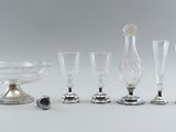 several glass and metal items are sitting on a white surface