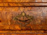 a wooden chest of drawers with brass handles on it
