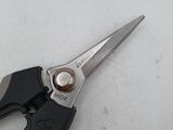 a pair of scissors on a measuring tape on a table