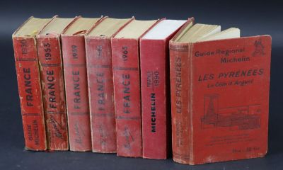 several red books are lined up on a black surface